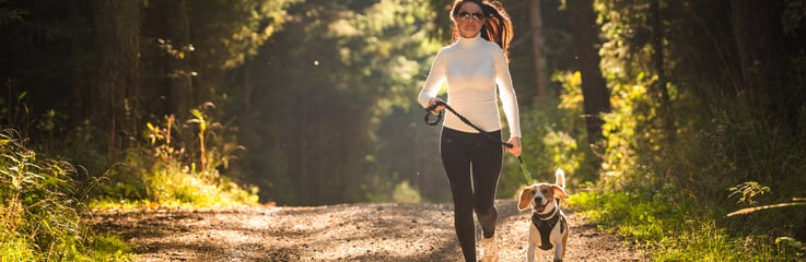 Runner with dog on a trail